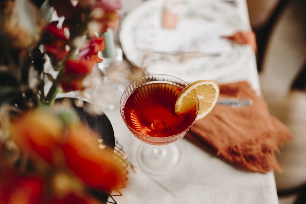 a glass with a drink and a slice of lemon